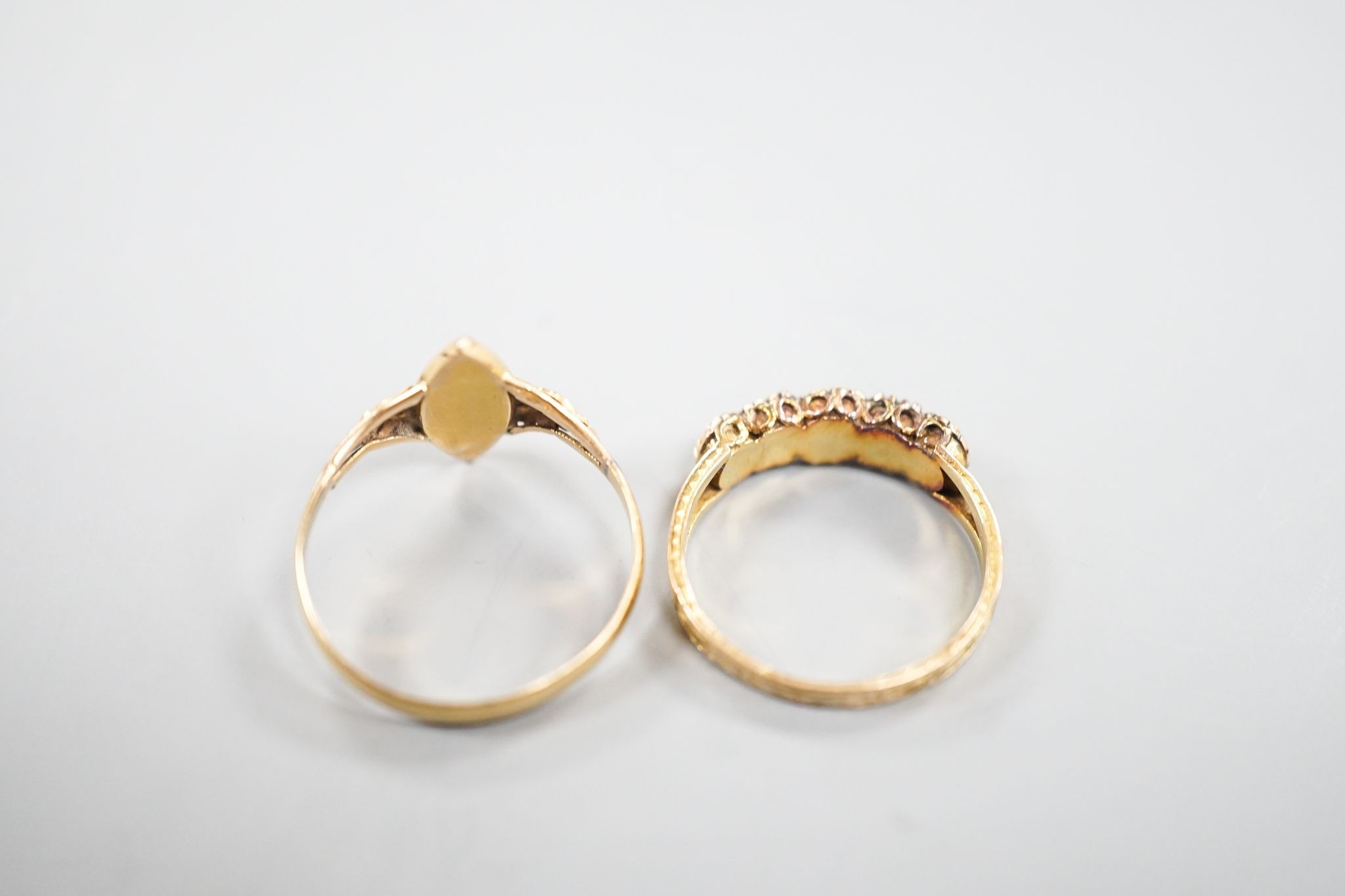 A Victorian 15ct gold, emerald and split pearl set five stone half hoop ring, size M, gross 1.9 grams and an early 20th century yellow metal and seed pearl set dress ring, size O, gross 1.7 grams.